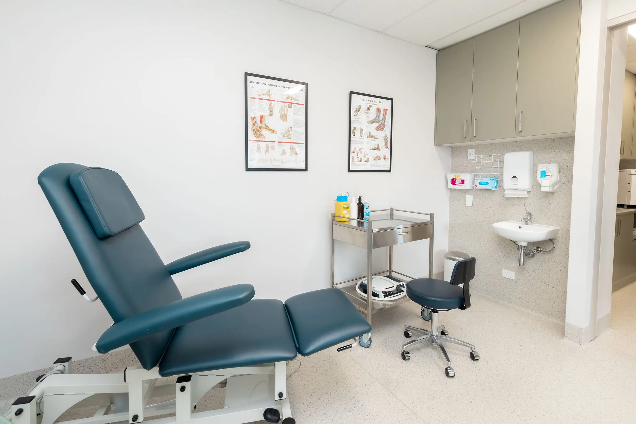 modern treatment operatory at austral podiatry with reclined patient chair and sink at podiatry clinic in austral, nsw