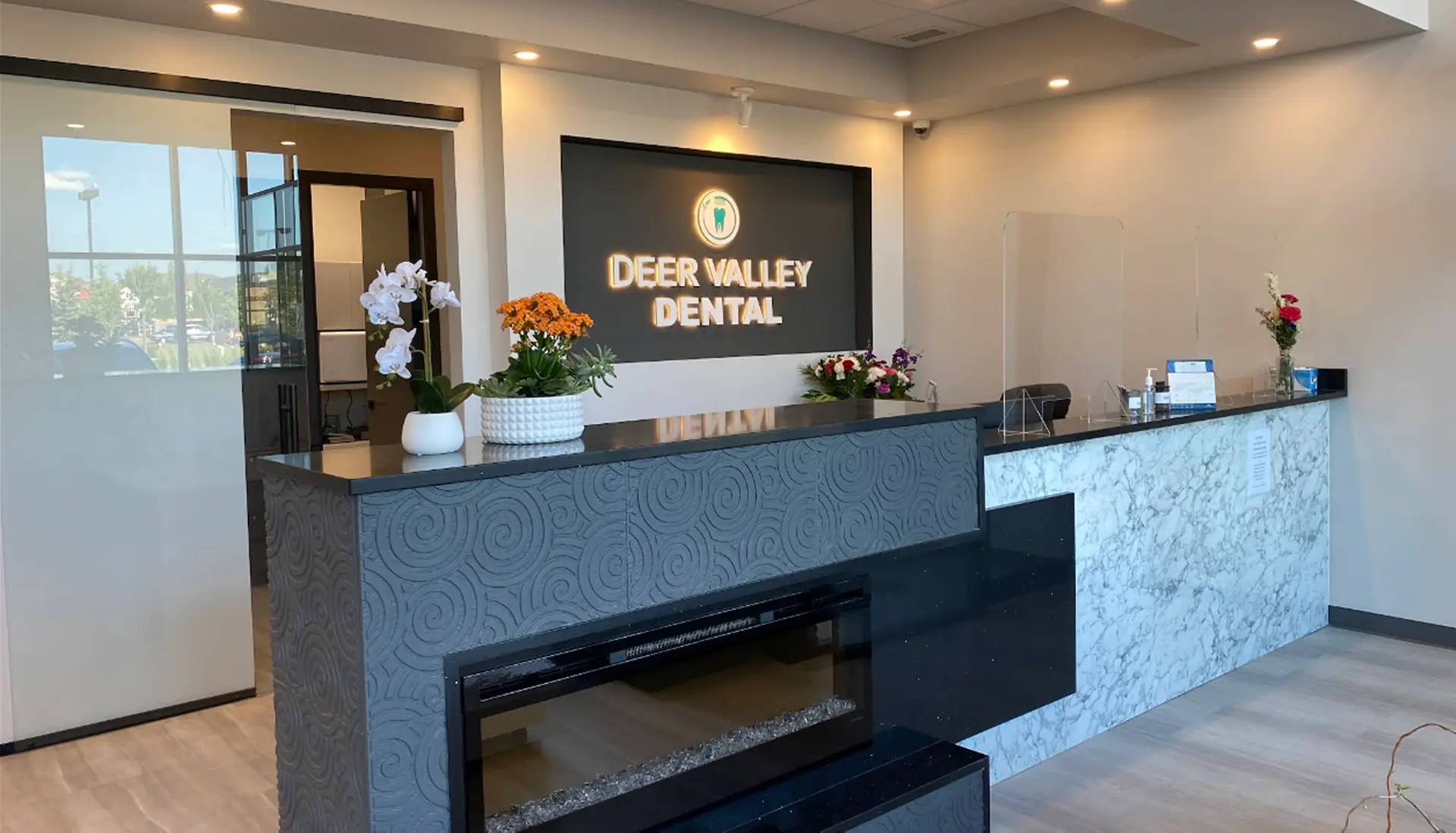 reception desk area and lobby of deer valley dental clinic in leduc, ab