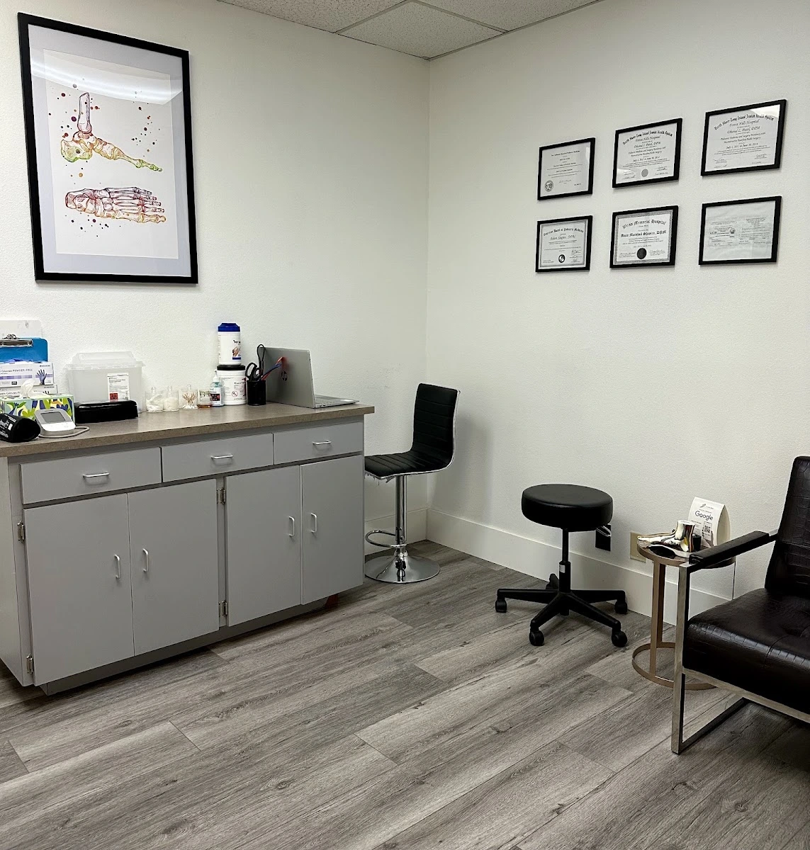 clean examination room with stool and supply cabinets at podiatrist office in upland, ca