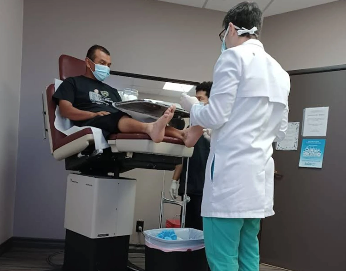 podiatrist examining patient foot in clinical examination room at podiatrist office near you