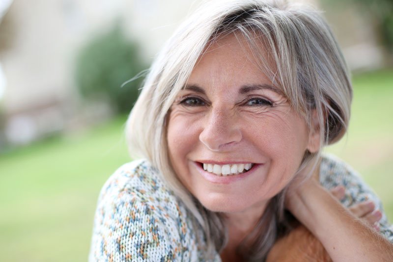 a dental patient smiling after a dental visit