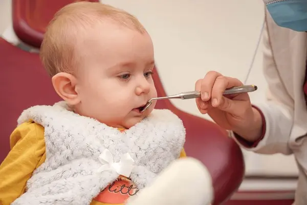 infant smiling happily at their first dental appointment