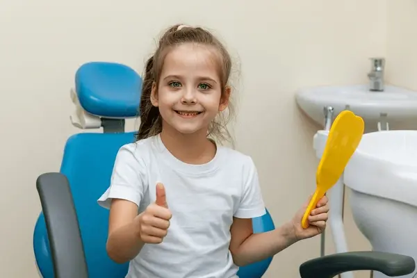 young child smiling during a routine dental visit